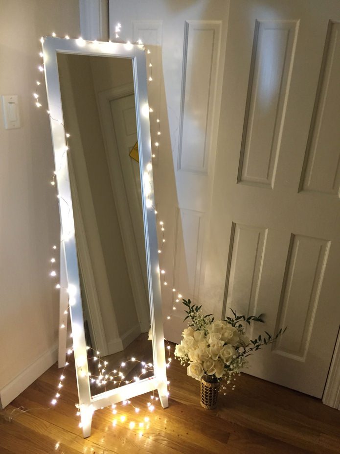 Decorating a mirror with a garland Decorating a mirror with a garland