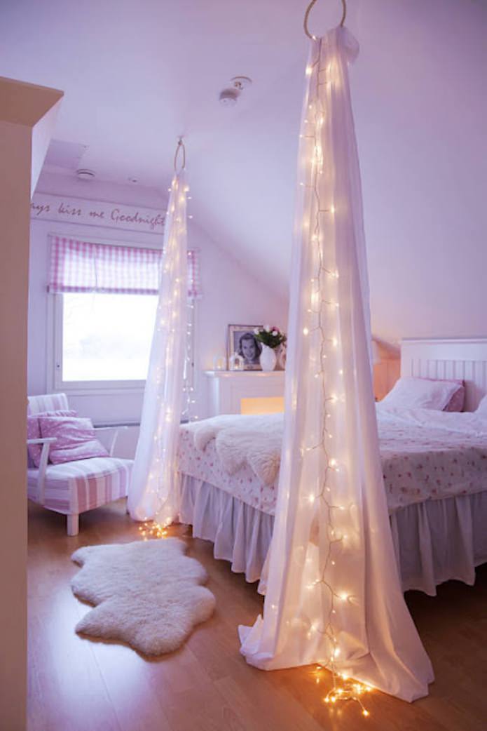 translucent fabric with garland by the bed translucent fabric with garland by the bed