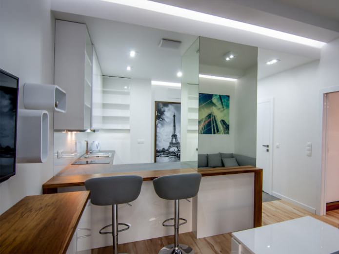 The interior of the combined kitchen-living room with a bar counter