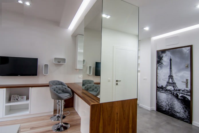 The interior of the combined kitchen-living room with a bar counter