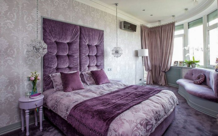 Gray-purple bedroom interior with a soft headboard Gray-purple bedroom interior with a soft headboard