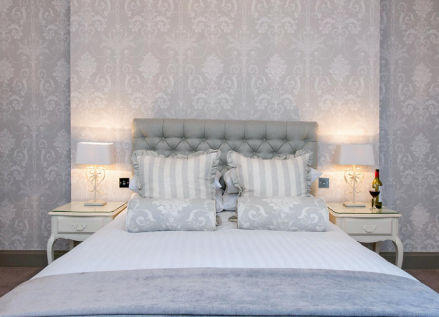 light gray wallpaper with a pattern in the bedroom