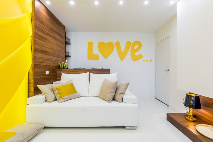 two-seater white sofa with pillows