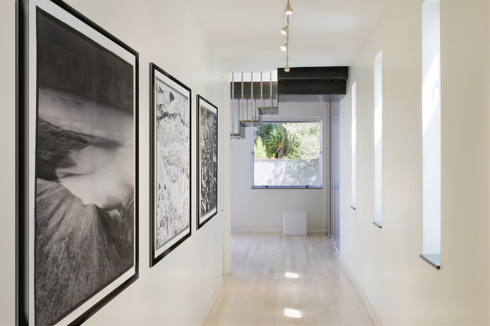 black and white paintings in the interior of the corridor