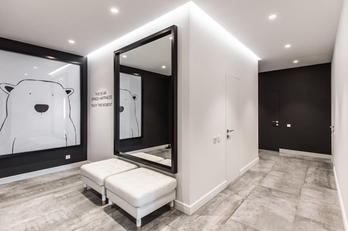 mirror in a black frame in the interior of the hallway mirror in a black frame in the interior of the hallway