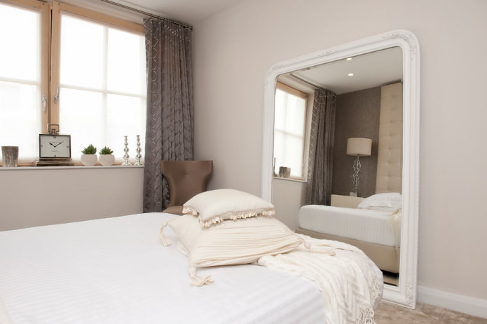 mirror in a white frame in the interior of the bedroom mirror in a white frame in the interior of the bedroom