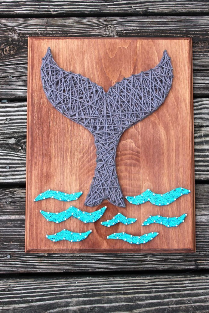 panel of threads and nails on the wall in the interior panel of threads and nails on the wall in the interior