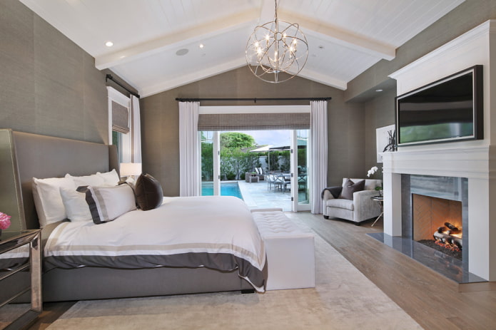 TV in the interior of the bedroom with a fireplace TV in the interior of the bedroom with a fireplace