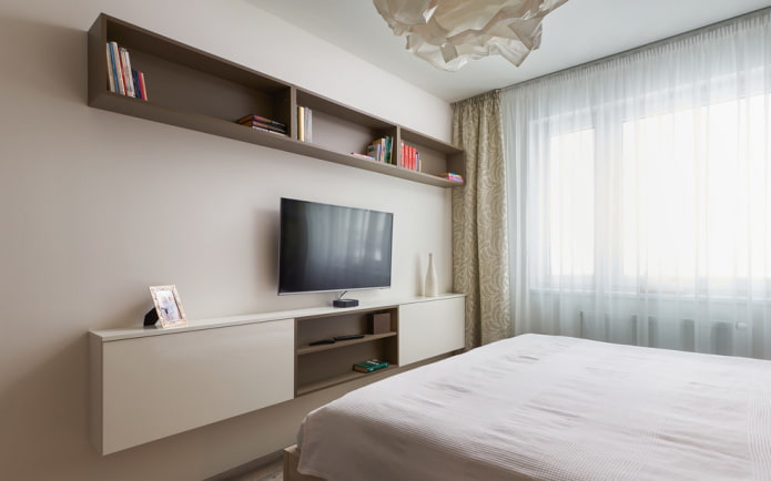 TV on the wall with shelves in the bedroom interior TV on the wall with shelves in the bedroom interior