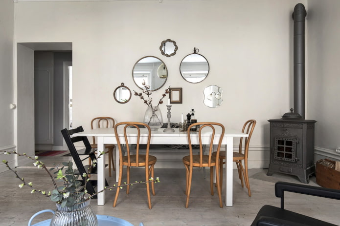 composition of mirrors on the wall in the interior of the dining room composition of mirrors on the wall in the interior of the dining room