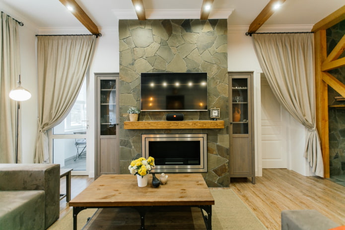 TV area with a wall of decorative stone in the interior