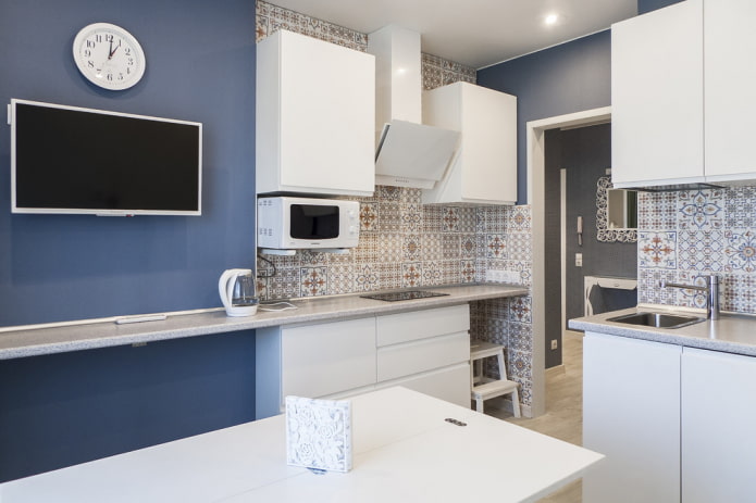 TV zone with a wall with a clock in the interior of the kitchen