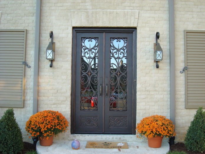 porch of a country house with an entrance door with wrought iron and glass porch of a country house with an entrance door with wrought iron and glass