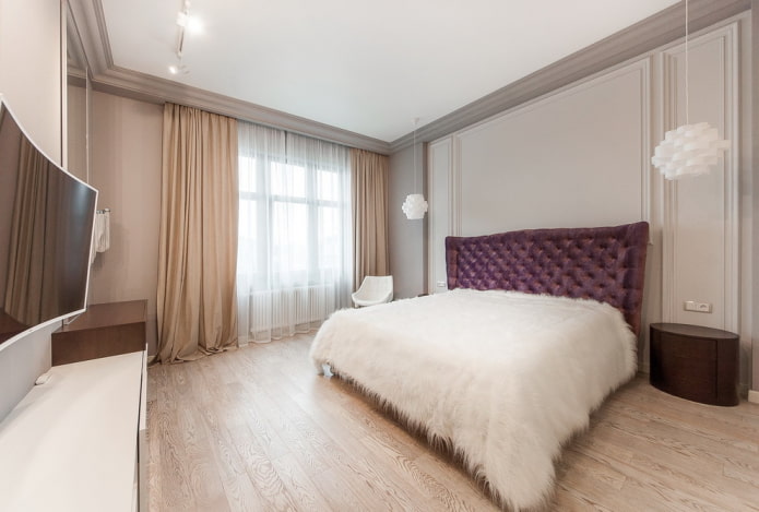 bed with white bedspread in the bedroom