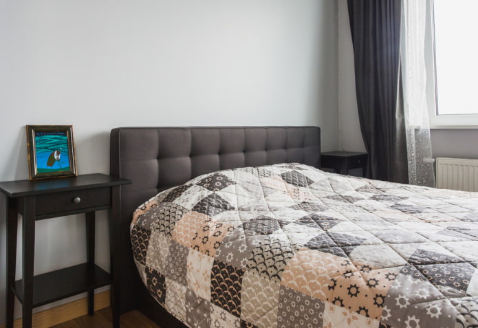 bed with a quilted bedspread in the bedroom