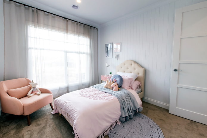 bed with a soft headboard in the interior of the nursery