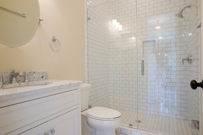 white tiles in the shower room in the bathroom