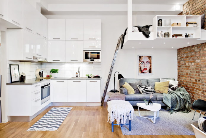 bed on the second level in the kitchen-living room bed on the second level in the kitchen-living room