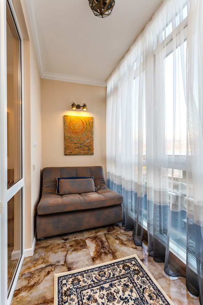 sofa in the interior of a narrow balcony