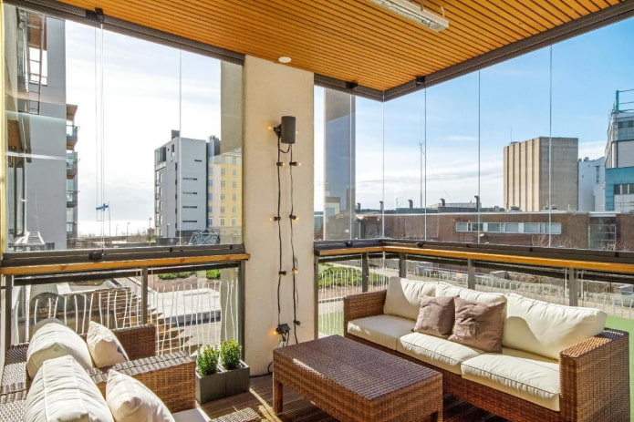 wicker sofa in the interior of the balcony