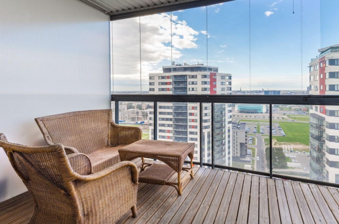 wicker sofa in the interior of the balcony
