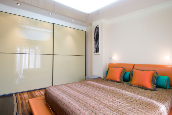 wardrobe with a glossy facade in the interior of the bedroom wardrobe with a glossy facade in the interior of the bedroom