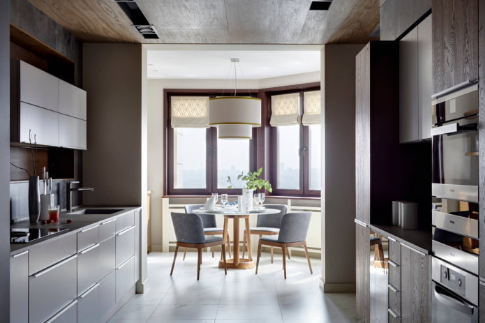 Two-row kitchen with a table in the bay window