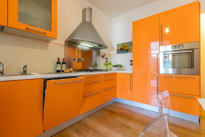 furniture and appliances in the interior of the kitchen in orange tones furniture and appliances in the interior of the kitchen in orange tones