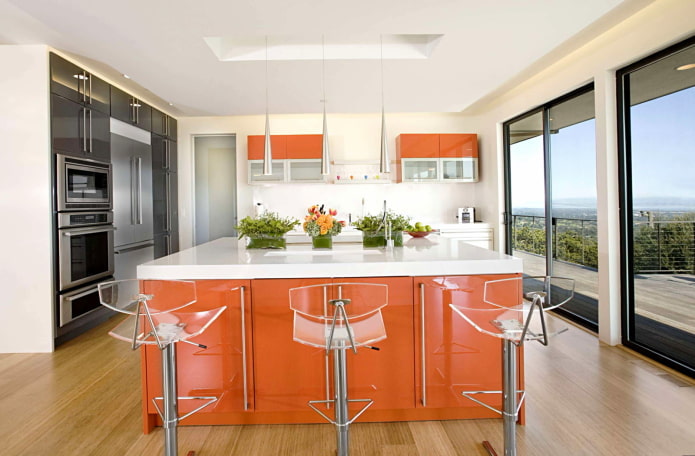 furniture and appliances in the interior of the kitchen in orange tones furniture and appliances in the interior of the kitchen in orange tones