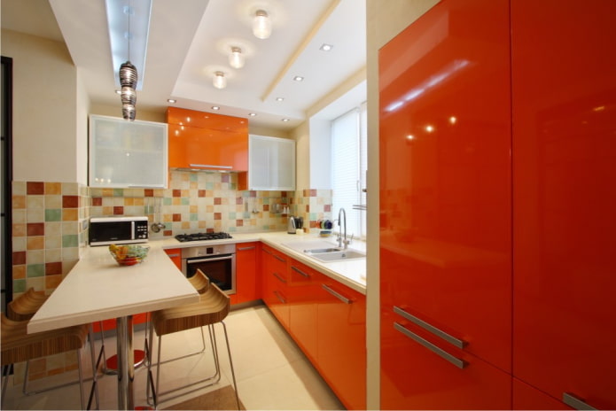 furniture and appliances in the interior of the kitchen in orange tones furniture and appliances in the interior of the kitchen in orange tones