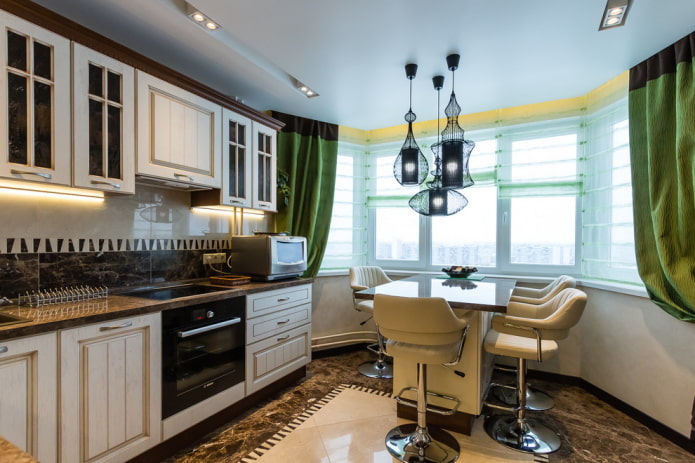 chandelier over the island in the interior of the kitchen
