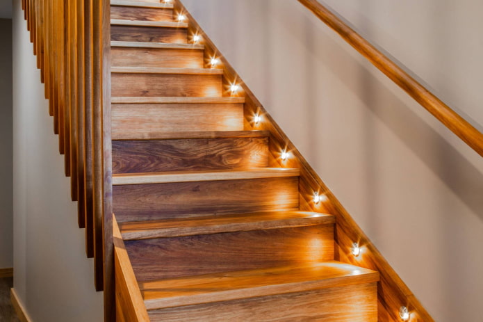 illuminated wooden staircase in the interior of the house illuminated wooden staircase in the interior of the house