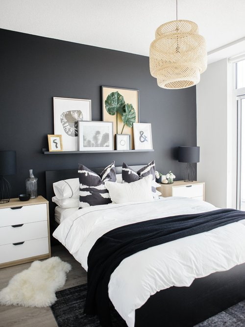shelf with paintings above the bed