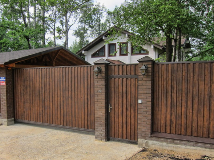 Beautiful fence made of profiled sheet under a tree Beautiful fence made of profiled sheet under a tree