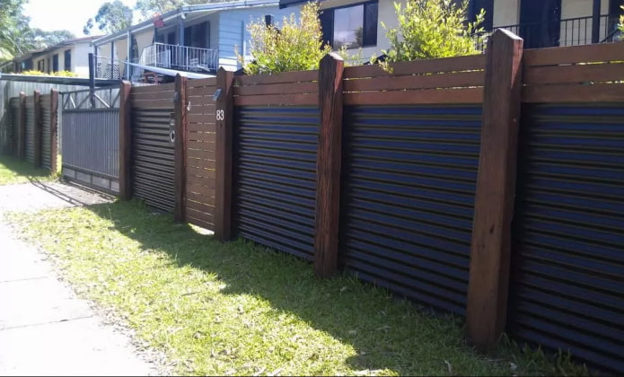 Fence made of profiled sheet with wooden posts Fence made of profiled sheet with wooden posts