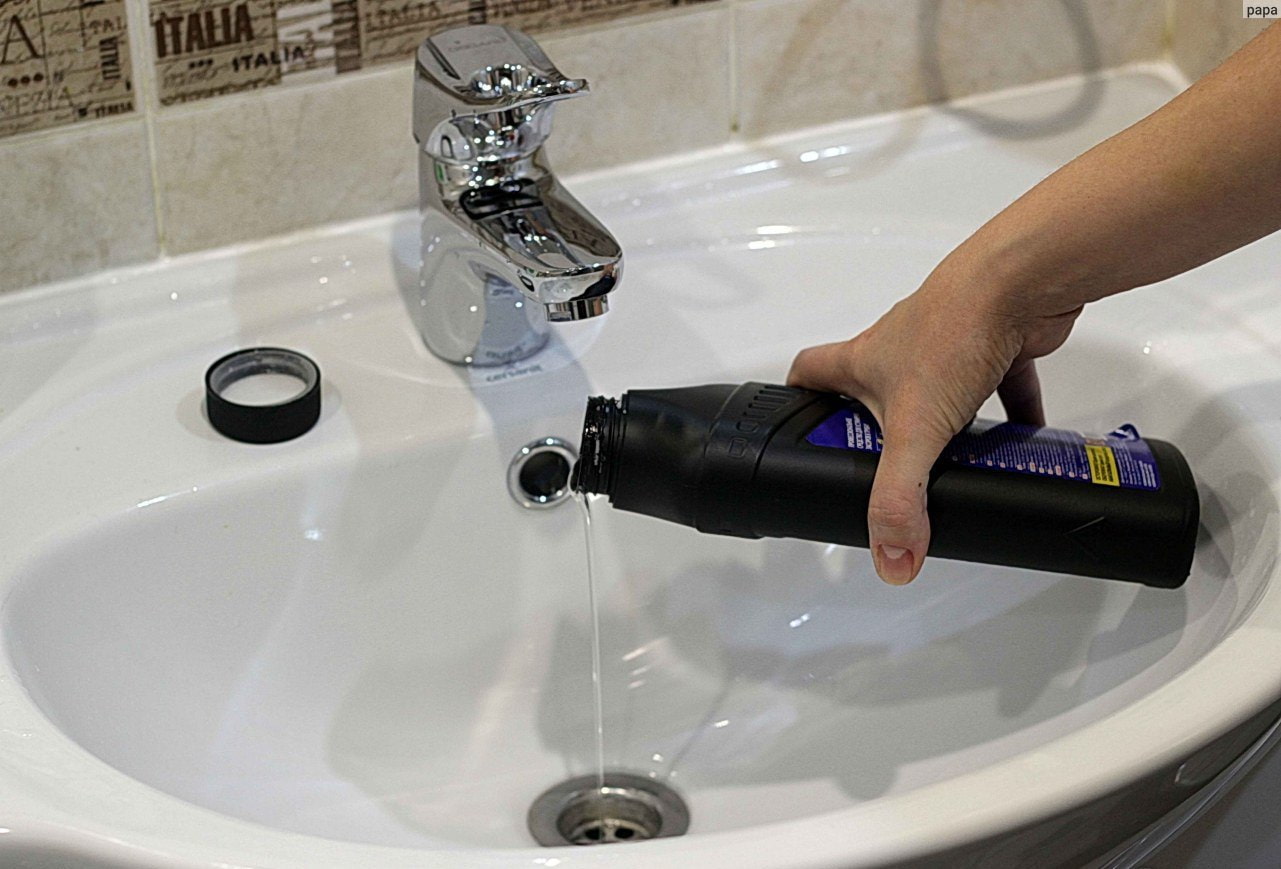 pouring the cleaning agent into the sink