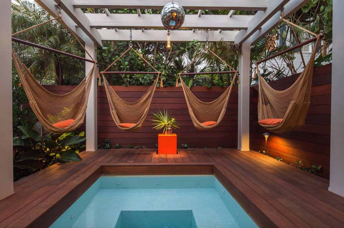 4 hammocks around the pool with pergola