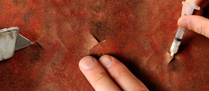 squeezing the glue out of the syringe squeezing the glue out of the syringe