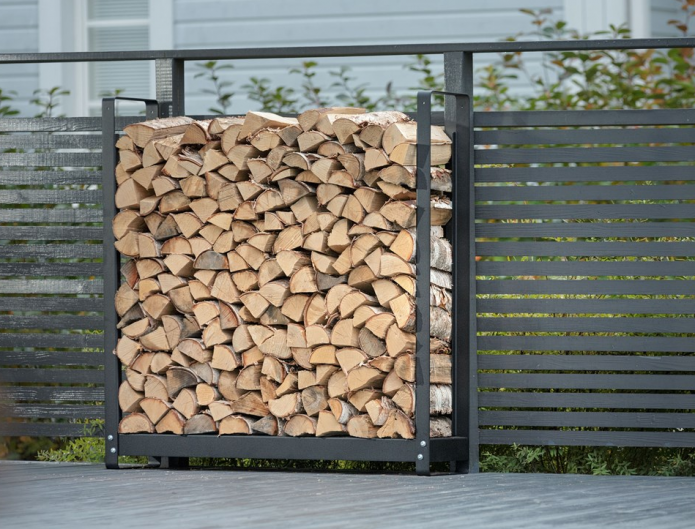 Woodshed by a metal fence Woodshed by a metal fence