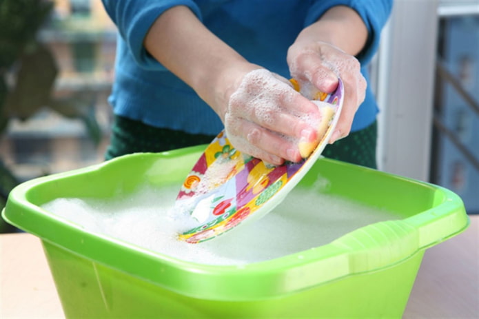 washing dishes in a basin