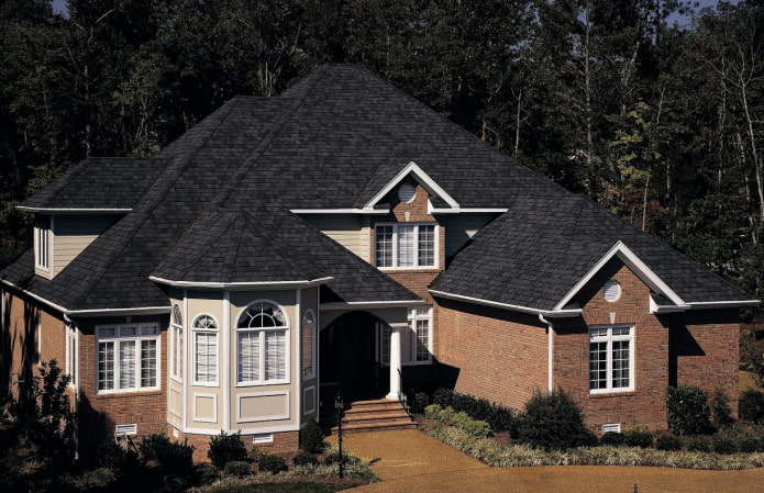 cottage with a black soft roof