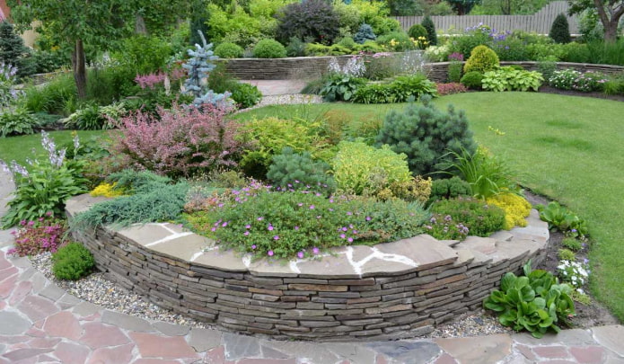 stepped border for a flower bed made of stone plates