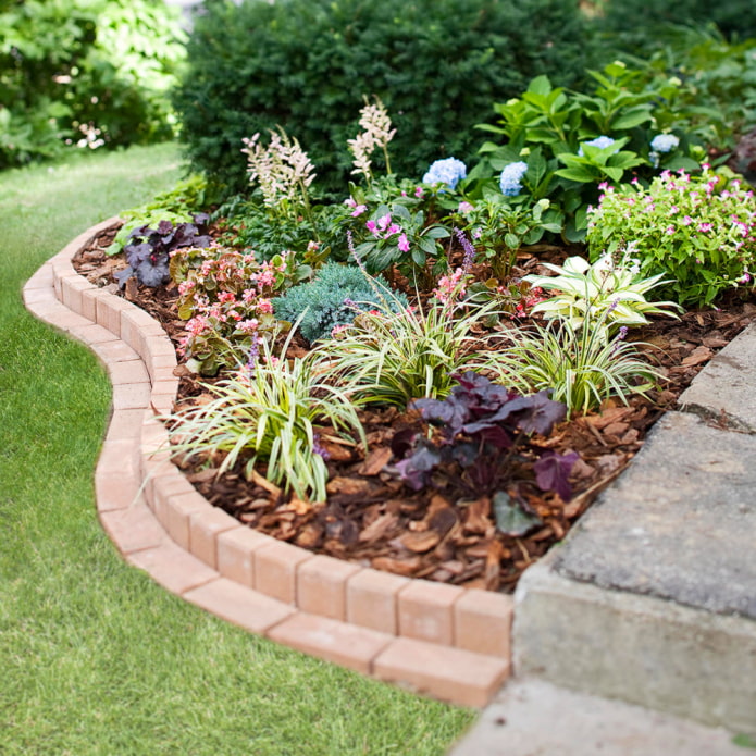 double curved border for a flower bed made of tiles