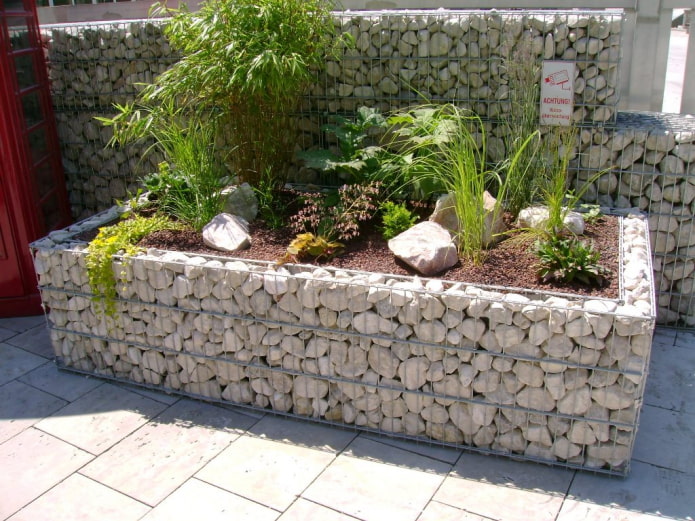 rectangular flower bed with a stone border in a wire frame