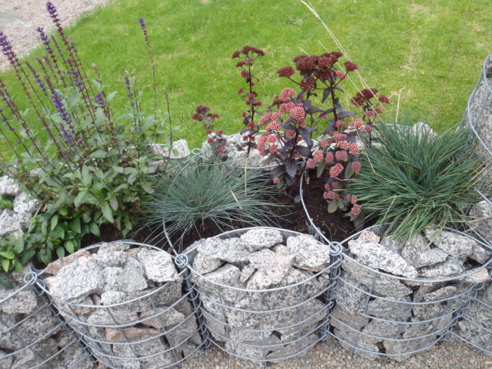 crushed stone flower garden fence in a shaped wire frame
