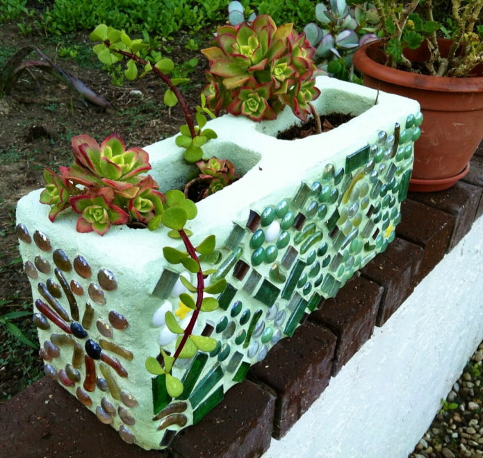 mini-flower bed made of a concrete block decorated with glass mosaic