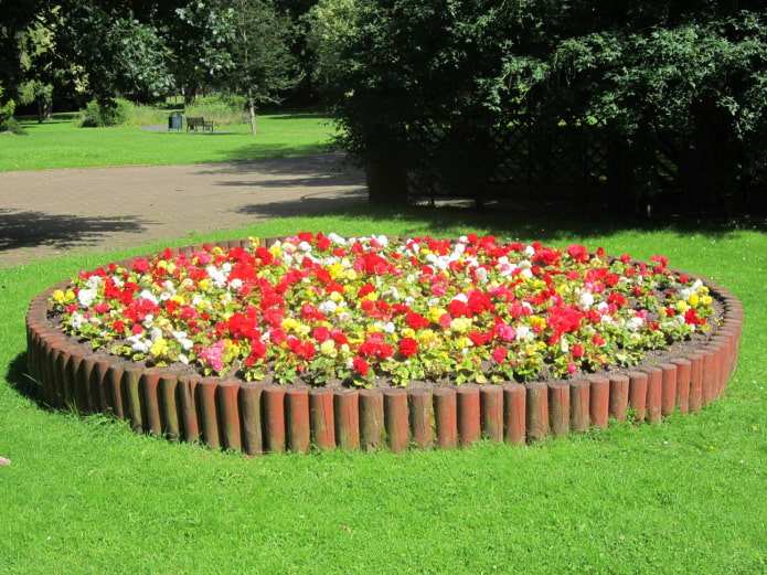 round flowerbed with a stockade border