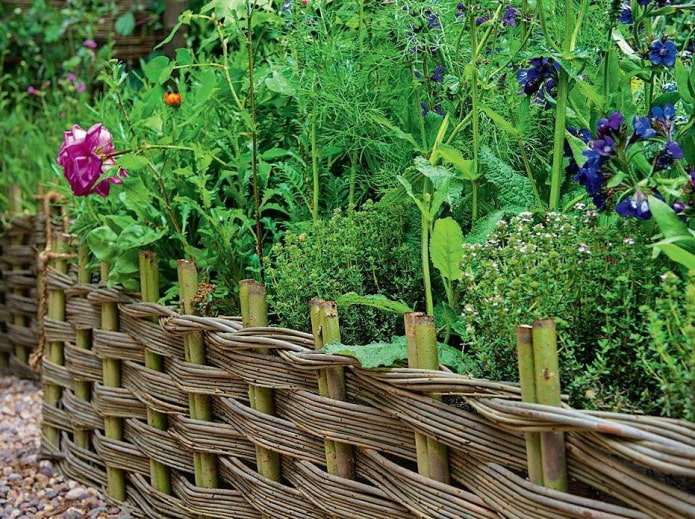 a fence made of thin twigs for a flower garden