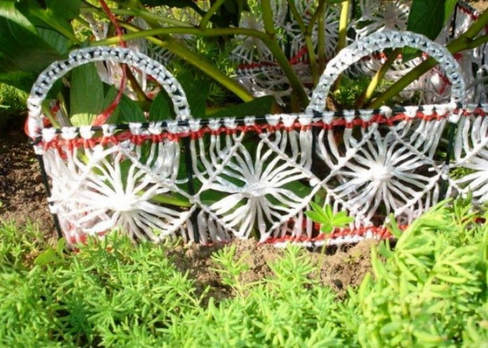 openwork fence for a flower bed made of ropes