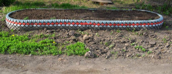 oval flower bed with a border of cut from tires and painted tread